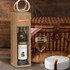 A jute wine carrier in natural brown holds a bottle of white wine, alongside a glass of wine and a picnic basket.