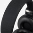 Black Bluetooth headphones with a textured headband and cushioned ear cups. Features branding on the side.
