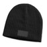 A black cable knit beanie with a patch, featuring a textured design.