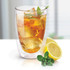 A double wall glass filled with iced tea, garnished with mint leaves, next to a slice of lemon. Features a logo.