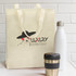 A natural look tote bag in cream colour, accompanied by a stainless steel drink bottle and a metal coffee cup.