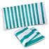 A striped beach towel in teal and white, featuring a logo, displayed flat and folded.