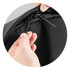 A black zippered compartment is being opened with two black zipper pulls. The fabric appears durable and textured.