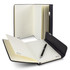 A Swiss Peak A5 notebook in black with lined pages, accompanied by a matching pen, displayed open and closed.