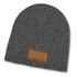 A grey cable knit beanie featuring a textured patch, designed for warmth and style.