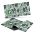 A desk mat featuring a leafy green design with various shades of green and a circular logo.