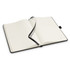 An open Petros Stone Paper Notebook with lined pages and a black cover, featuring a ribbon bookmark.