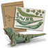 A wooden model of a Tuatara in green and brown, with assembly instructions and parts displayed on a card.