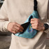 A full-colour Glastonbury belt bag in blue, features a front zip pocket and includes a logo.