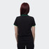 A women's black polo shirt featuring green trim on the collar and sleeves. The shirt has a logo on the front.