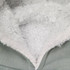 A detail of a soft, fluffy inner lining in a hoodie, featuring grey outer material and textured white fleece.