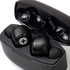 A pair of black wireless earbuds inside a sleek black charging case, featuring a logo on the earbuds.