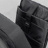 A black anti-theft backpack briefcase with multiple internal compartments and a logo tag.