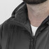 A black puffer jacket with a high collar and zipper closure, featuring a small logo on the chest.
