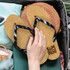 A pair of black and tan Fiji flip flops resting on a travel bag alongside a straw accessory.