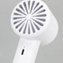 A white personal cooling fan featuring a circular grill design, with a charging port at the base.
