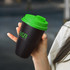 A drink bottle with a black body and green lid, featuring a logo on the side.