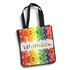 A vibrant tote bag featuring a multicoloured fruit design and black straps. It has a logo on the front.