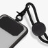 A black phone lanyard with a clear protective case, featuring a secure attachment clip and a circular adjustment piece.