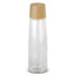 A drink bottle in transparent glass with a light wood lid, featuring a minimalist and sleek design.