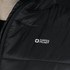A close-up of a black puffer vest featuring a logo. The fabric appears smooth and insulated.