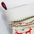 A festive Christmas stocking in white, red, and green, featuring a soft top and decorative patterns.