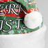 A festive Santa hat featuring a red and green pattern with white trim and a pom-pom on top.