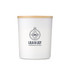 A large white glass candle with a wooden lid and a logo, featuring a floral design.