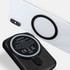 A black wireless charging power bank with a circular magnetic attachment and a smartphone in the background.