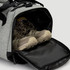 A grey duffle bag with a zippered compartment revealing a pair of brown hiking boots inside.