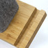 A bamboo desk caddy in a light wood finish, featuring a grey felt section on top.