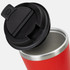 A red coffee cup with a silver base and a black lid. The cup is shown from an angle, showcasing the interior.