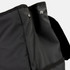 A black backpack featuring a textured fabric, with a closure flap and buttons at the top. It has a logo present.
