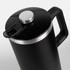 A black coffee press with a stainless steel lid and handle, designed for brewing coffee.