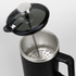 A black coffee press with a stainless steel interior and a transparent lid, featuring a plunger mechanism.