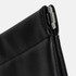 A black tech and accessory pouch with a silver zipper pull, featuring sleek stitching and a smooth finish.