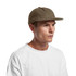 A wool cap in earthy brown, featuring a flat brim and a minimalistic design. It has a logo on the side.