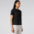 A black short-sleeve tee displayed on a model, paired with light-coloured pants. The tee has a simple design and a logo.