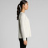 A long-sleeved tee in faded white, featuring a relaxed fit and a side view of a model wearing it.