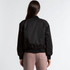 A black varsity bomber jacket with a relaxed fit and ribbed cuffs, showcased from the back.