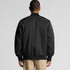 A black college bomber jacket with a relaxed fit, featuring a ribbed collar and cuffs, and a logo on the back.