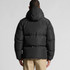 A hooded puffer jacket in black, featuring a plush design and a rear view displaying the hood and quilting.