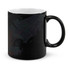 A coffee mug featuring a black exterior with a white interior and abstract designs. It has a handle and a logo.