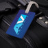 A PVC luggage tag in blue attached to a black suitcase, featuring a logo on the tag.