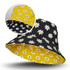 A reversible bucket hat featuring a yellow floral pattern on one side and a black floral pattern on the other.