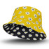 A yellow reversible bucket hat with a daisy pattern on one side and a solid black interior.