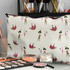 A large cosmetic bag featuring a floral design in pastel colours, with a subtle logo and various makeup items displayed nearby.