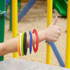 A wrist adorned with colorful silicone flyers, including red, orange, green, black, yellow, and blue discs. 