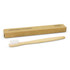 A bamboo toothbrush in natural colour, alongside a recyclable cardboard box. The toothbrush has white bristles.