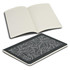 A recycled cotton cahier notebook with a black patterned cover and blank pages inside, featuring a branding logo.